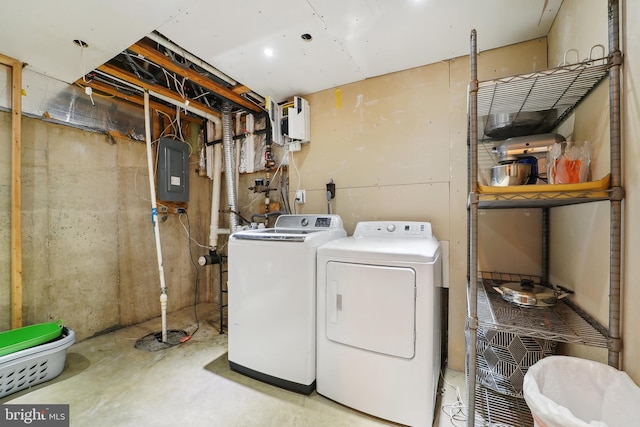 washroom with washing machine and dryer, laundry area, and electric panel