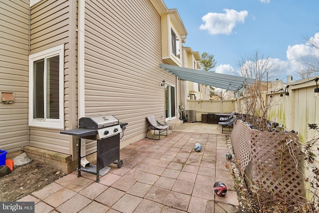 view of patio with a fenced backyard, area for grilling, and central AC unit