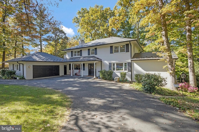 view of front facade with a garage and a porch