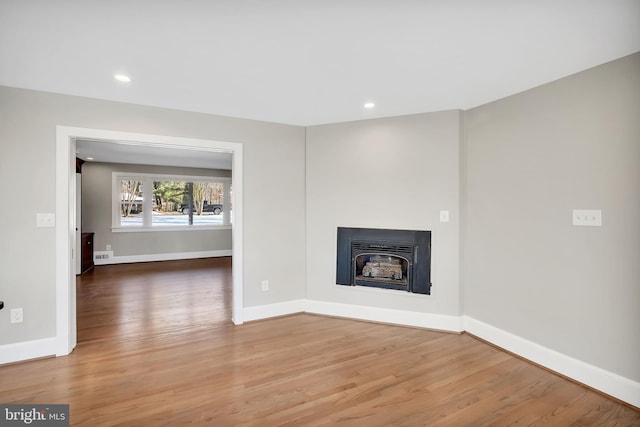 unfurnished living room with wood-type flooring