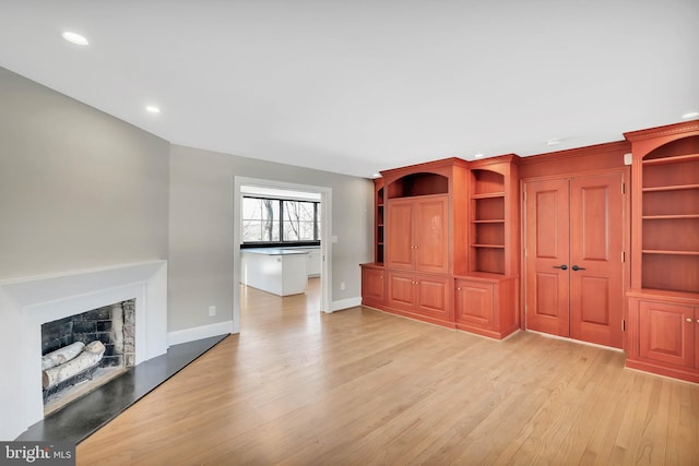 unfurnished living room with light hardwood / wood-style flooring