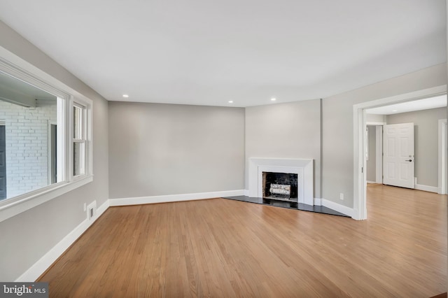 unfurnished living room with light hardwood / wood-style floors