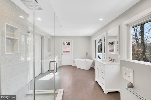 bathroom with vanity, a wealth of natural light, tile patterned floors, and independent shower and bath