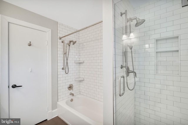 bathroom featuring combined bath / shower with glass door