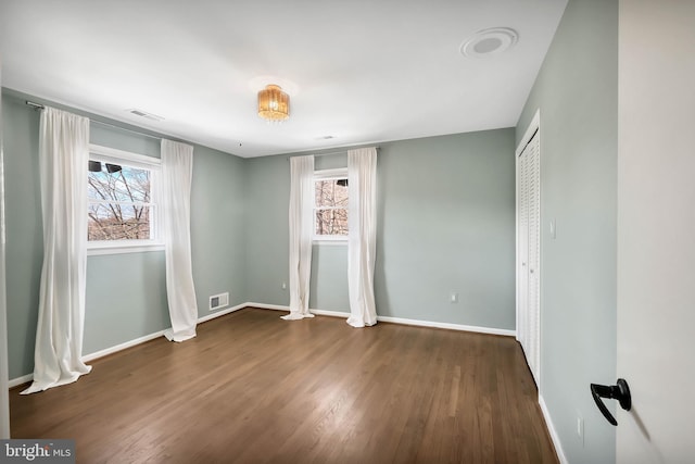 unfurnished bedroom with dark hardwood / wood-style floors