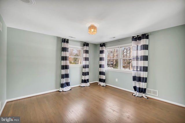 unfurnished room with hardwood / wood-style floors