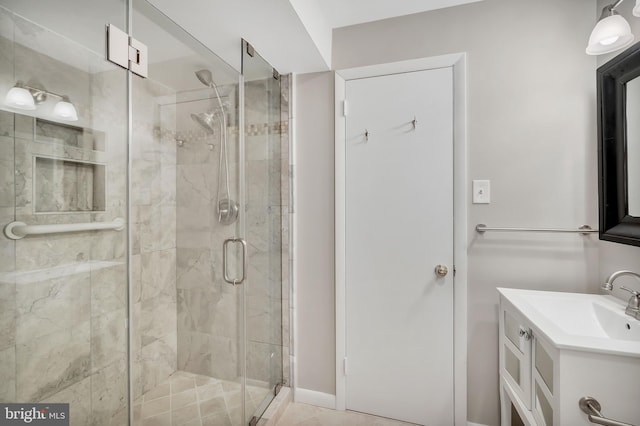 bathroom featuring an enclosed shower and vanity