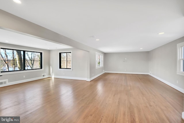 unfurnished living room with light hardwood / wood-style flooring and plenty of natural light