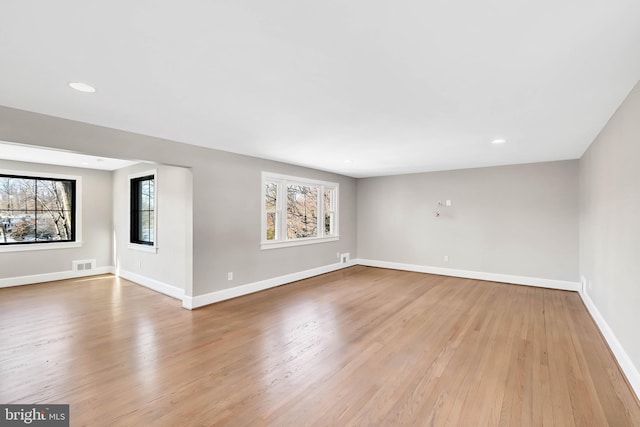 empty room featuring light hardwood / wood-style flooring and a wealth of natural light