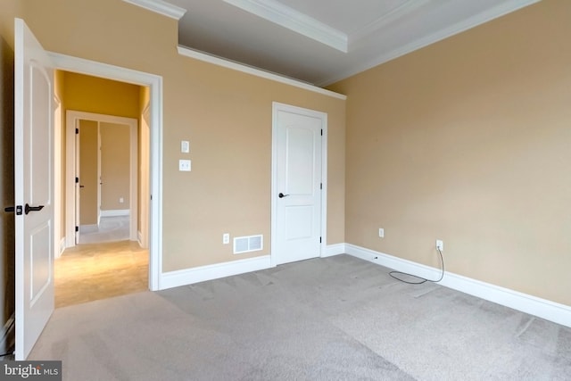 unfurnished bedroom featuring light colored carpet and ornamental molding