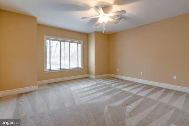 empty room with ceiling fan and light colored carpet