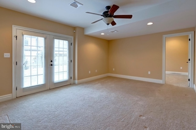 carpeted empty room with ceiling fan and french doors