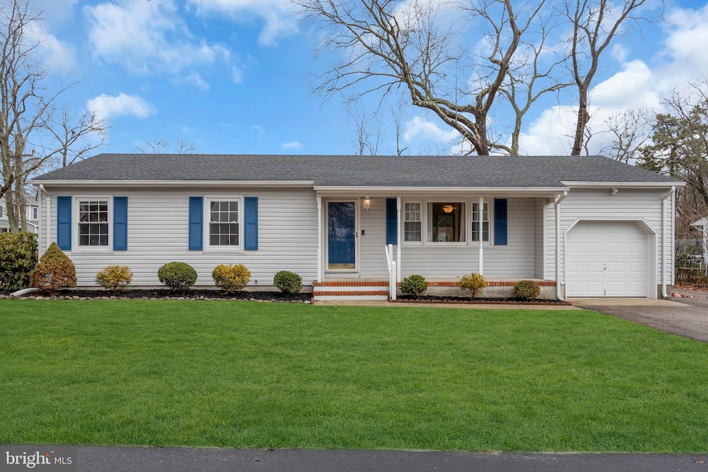 ranch-style house with a garage and a front yard