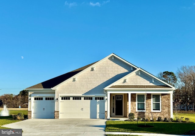 craftsman-style home with a garage and a front yard