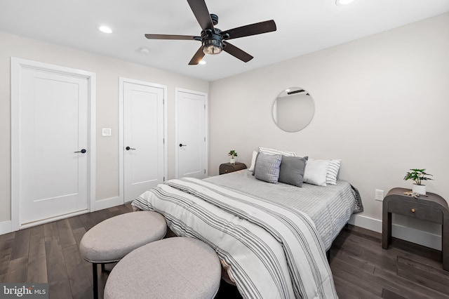 bedroom featuring dark wood-type flooring, recessed lighting, ceiling fan, and baseboards