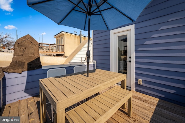 wooden terrace with outdoor dining space