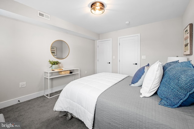 bedroom with carpet floors, baseboards, and visible vents