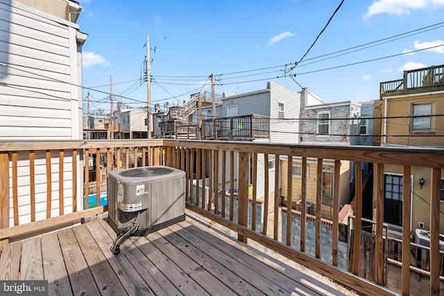 wooden terrace featuring cooling unit and a residential view