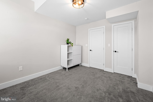 unfurnished bedroom with carpet and baseboards