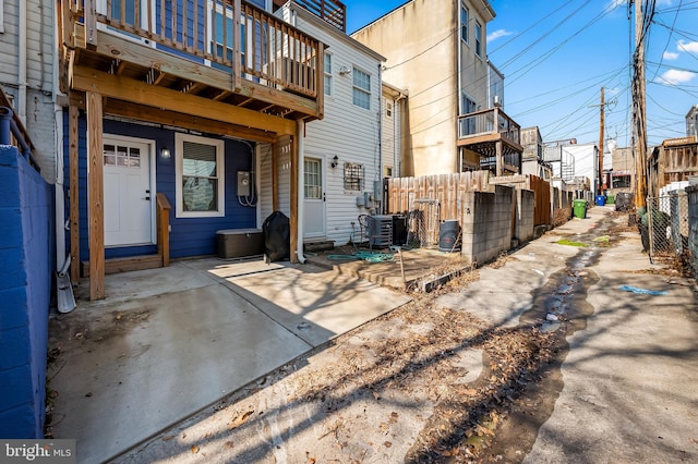 exterior space featuring fence, central AC unit, and a patio