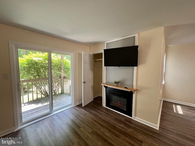 unfurnished living room featuring dark hardwood / wood-style flooring