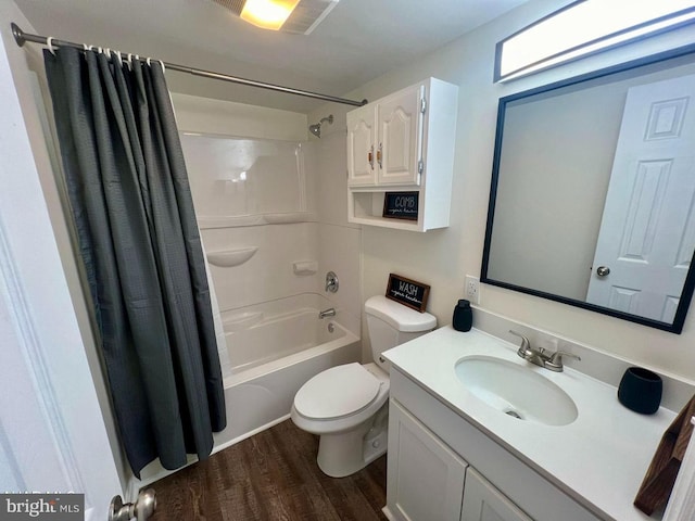 full bathroom featuring hardwood / wood-style flooring, vanity, toilet, and shower / bath combination with curtain