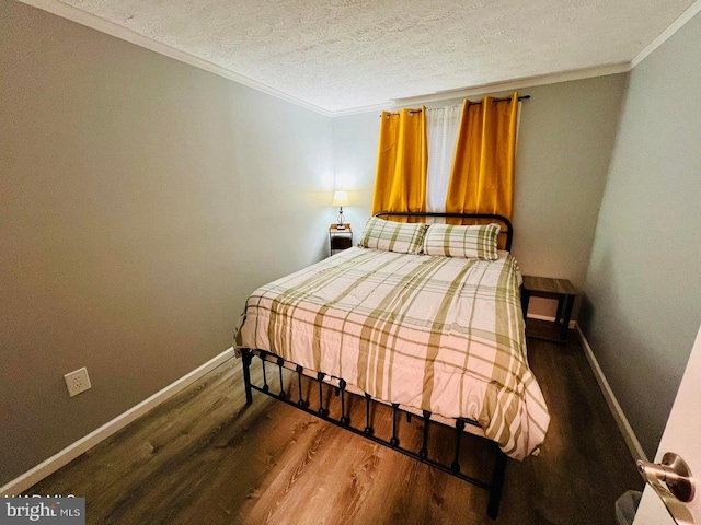 bedroom featuring ornamental molding, a textured ceiling, and dark hardwood / wood-style flooring