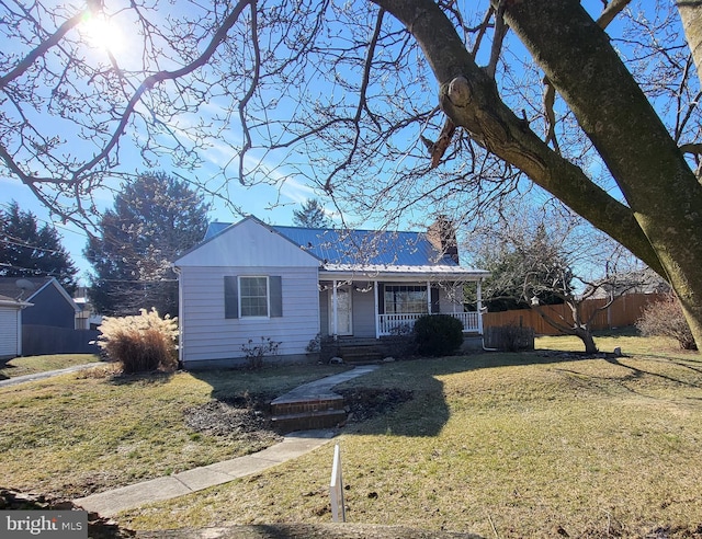 ranch-style house featuring a front yard and a porch