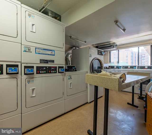 shared laundry area featuring stacked washer and clothes dryer