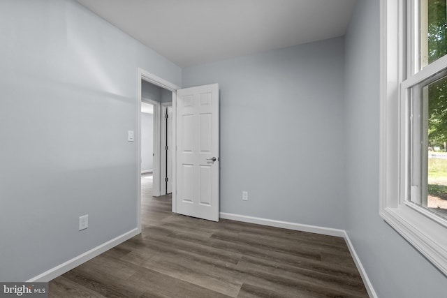 spare room featuring dark wood-type flooring