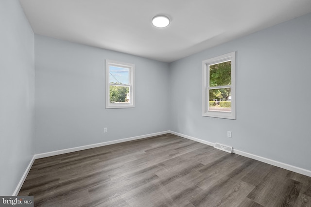 spare room with wood-type flooring