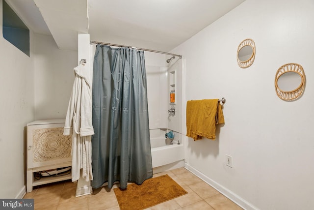 full bath with shower / tub combo, baseboards, and tile patterned floors