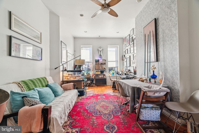 interior space with a ceiling fan and wood finished floors