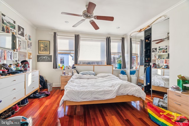 bedroom with multiple windows, crown molding, and hardwood / wood-style flooring