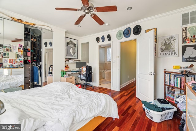 bedroom featuring a ceiling fan, ornamental molding, a closet, and wood finished floors