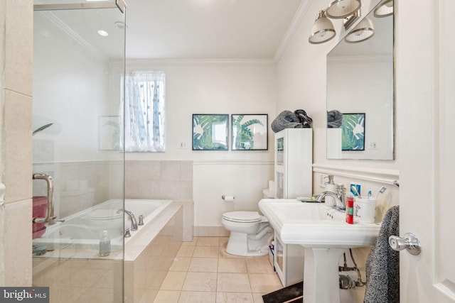 bathroom featuring toilet, tile patterned flooring, tiled tub, and crown molding