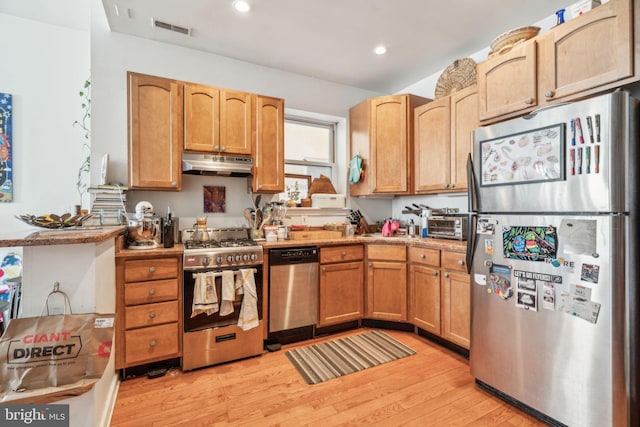 kitchen featuring recessed lighting, under cabinet range hood, visible vents, appliances with stainless steel finishes, and light wood finished floors