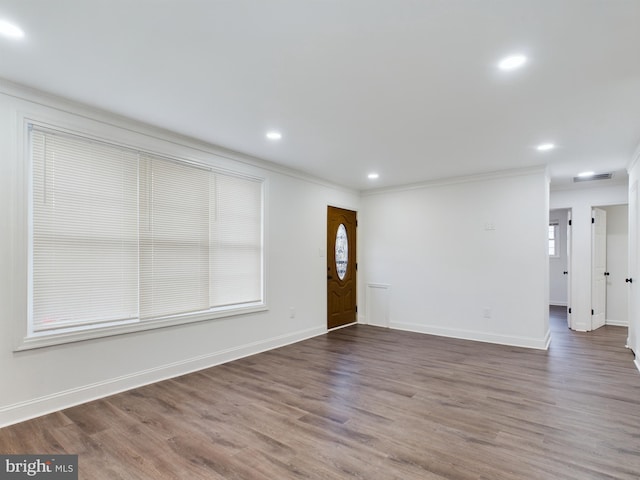 unfurnished room featuring crown molding and dark hardwood / wood-style floors