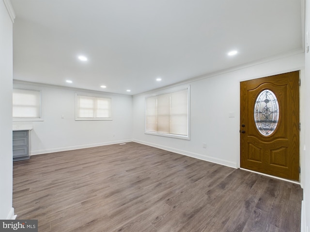 foyer entrance with wood-type flooring and ornamental molding