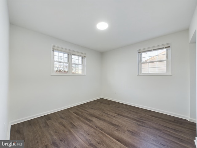 spare room with dark hardwood / wood-style floors