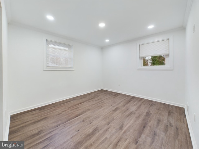 unfurnished room with hardwood / wood-style floors and ornamental molding