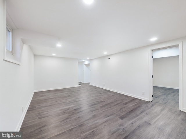 basement featuring dark hardwood / wood-style flooring