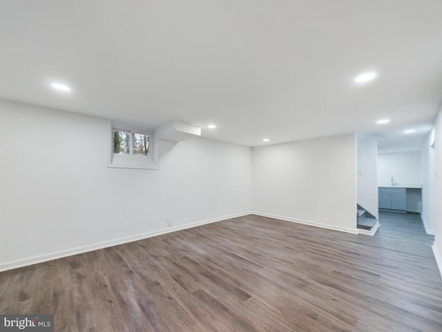 basement with hardwood / wood-style floors