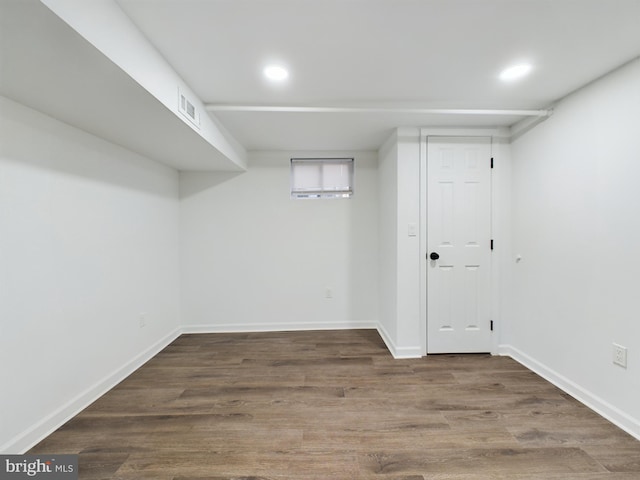 basement with dark hardwood / wood-style flooring