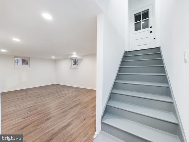 stairs featuring hardwood / wood-style flooring