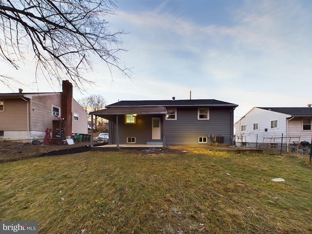 rear view of property featuring a yard