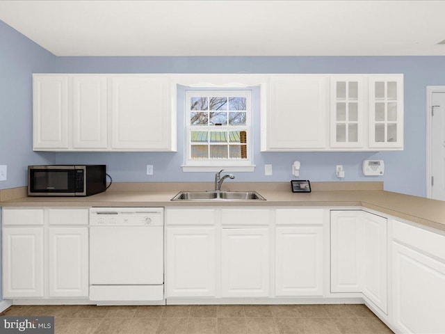 kitchen featuring a sink, white cabinets, light countertops, dishwasher, and stainless steel microwave