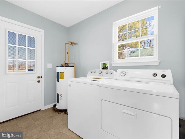 clothes washing area featuring laundry area, electric water heater, baseboards, and separate washer and dryer