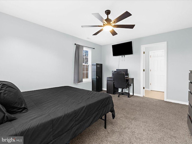 carpeted bedroom with ceiling fan and baseboards