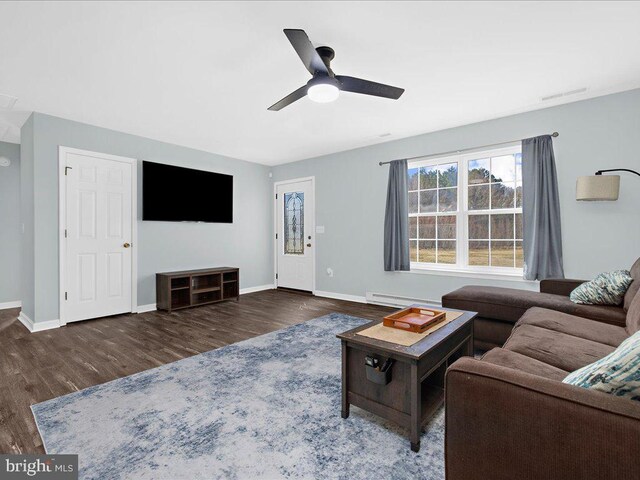 living room featuring a baseboard heating unit, wood finished floors, a ceiling fan, and baseboards